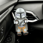 Image of Star Wars The Mandalorian Hug Buddy in a car attached to the air vent, with arms and legs closed ready to hold your phone