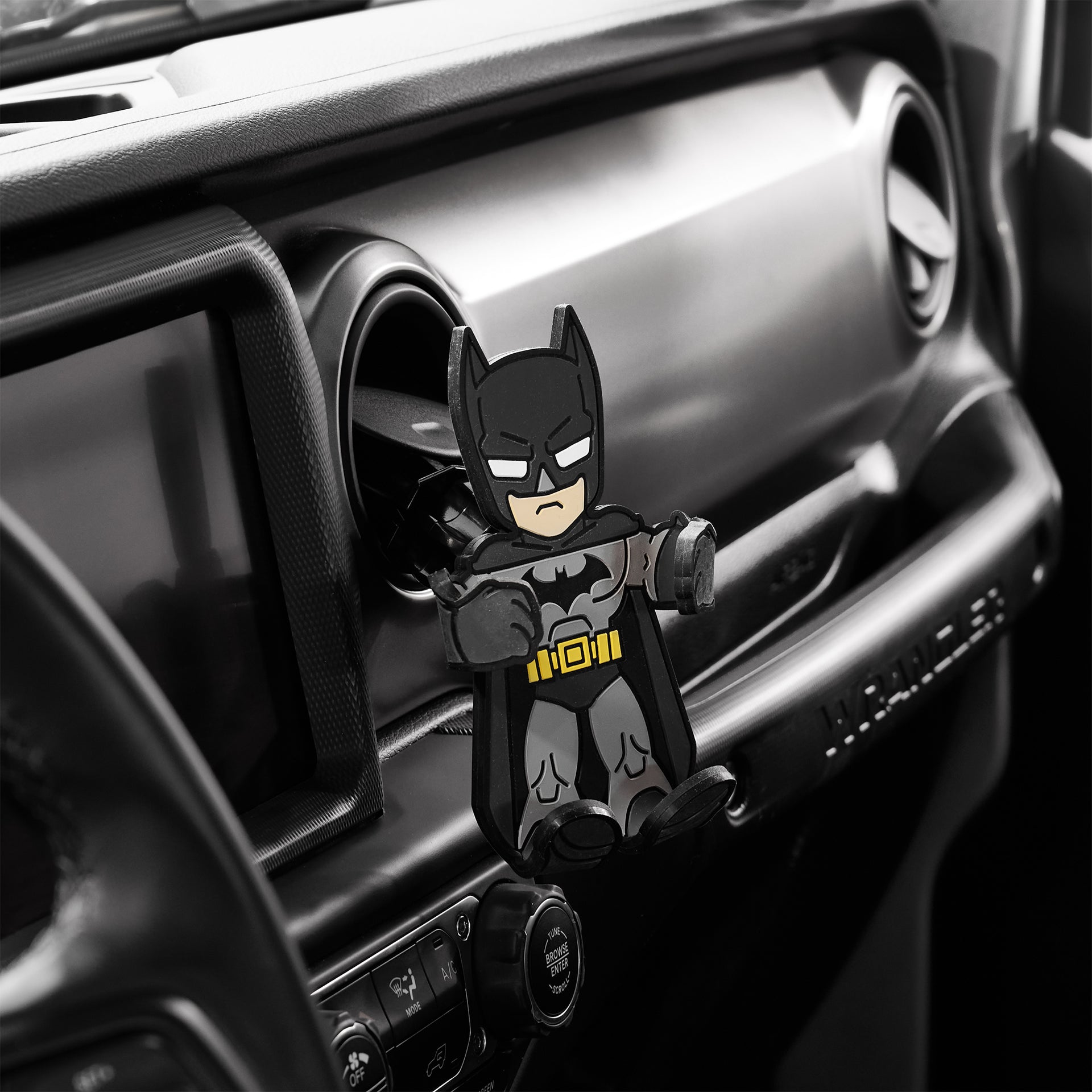 Image of Batman Hug Buddy attached to a car air vent, waiting for your phone or smart device.
