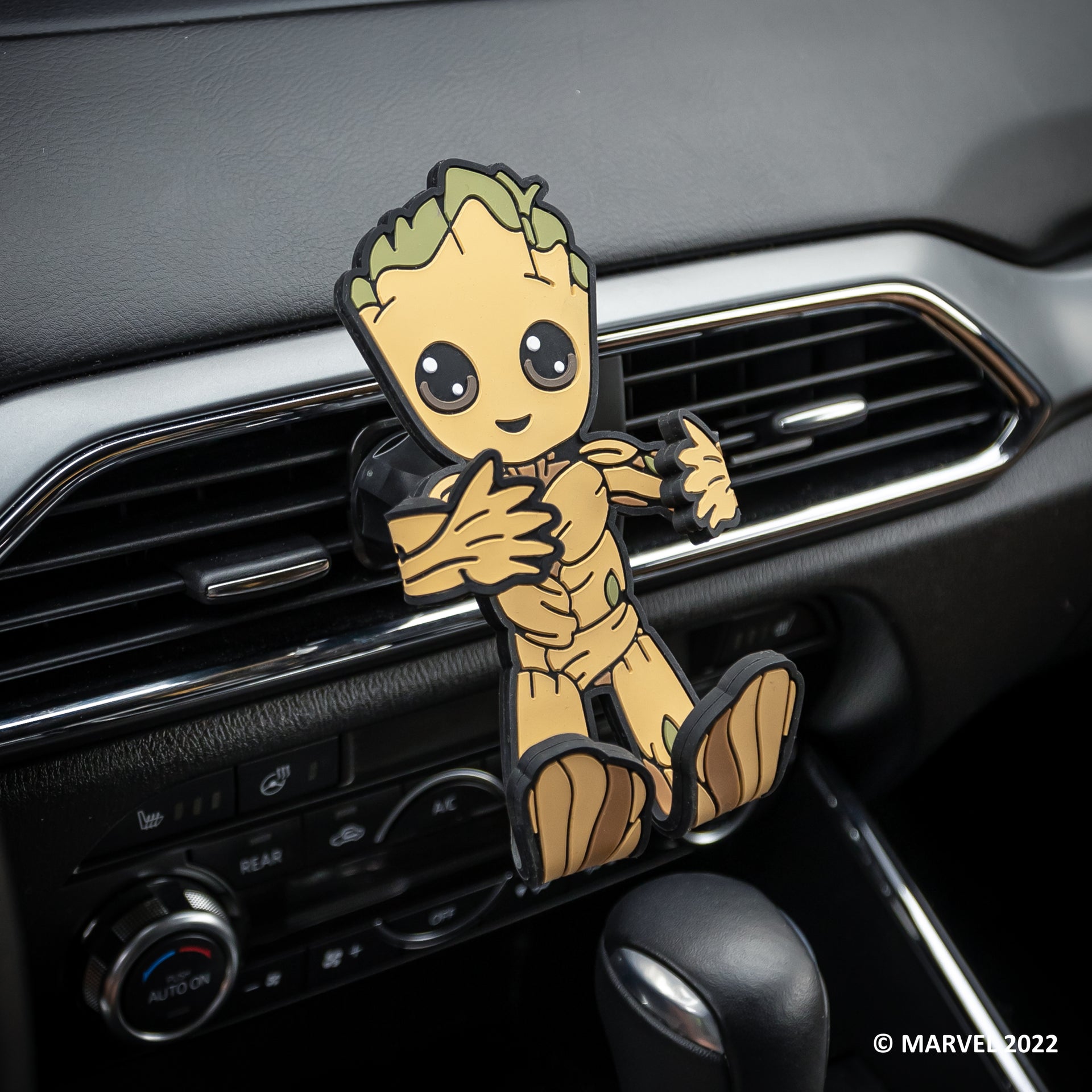 Image of Marvel Groot Hug Buddy attached to a car air vent, awaiting a cell-phone to be placed in its grasp