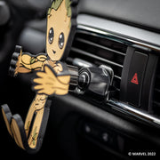 Image of Marvel Groot Hug Buddy attached to a car air vent, awaiting a cell-phone to be placed in its grasp. Close-up on the vent clip attached the vehicle air vent.