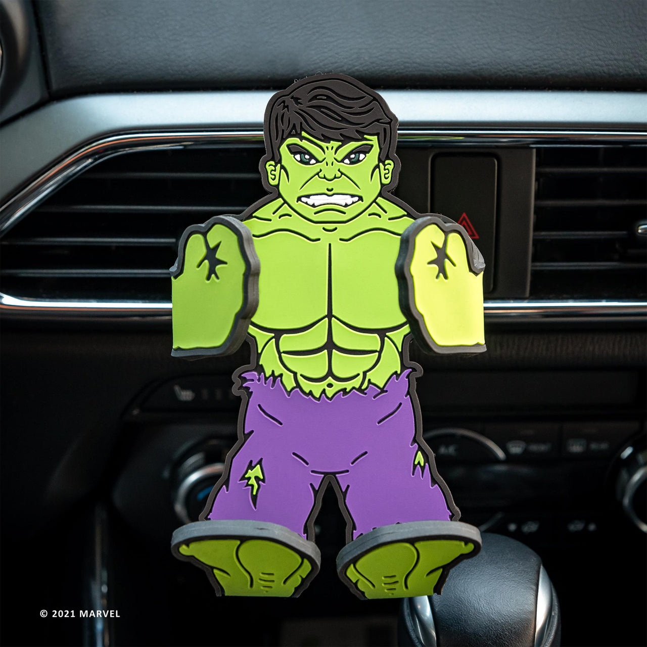 Image of Marvel Comics Hulk Hug Buddy attached to a car air vent with arms and legs in the closed position ready to hold a phone or smart device on your next journey