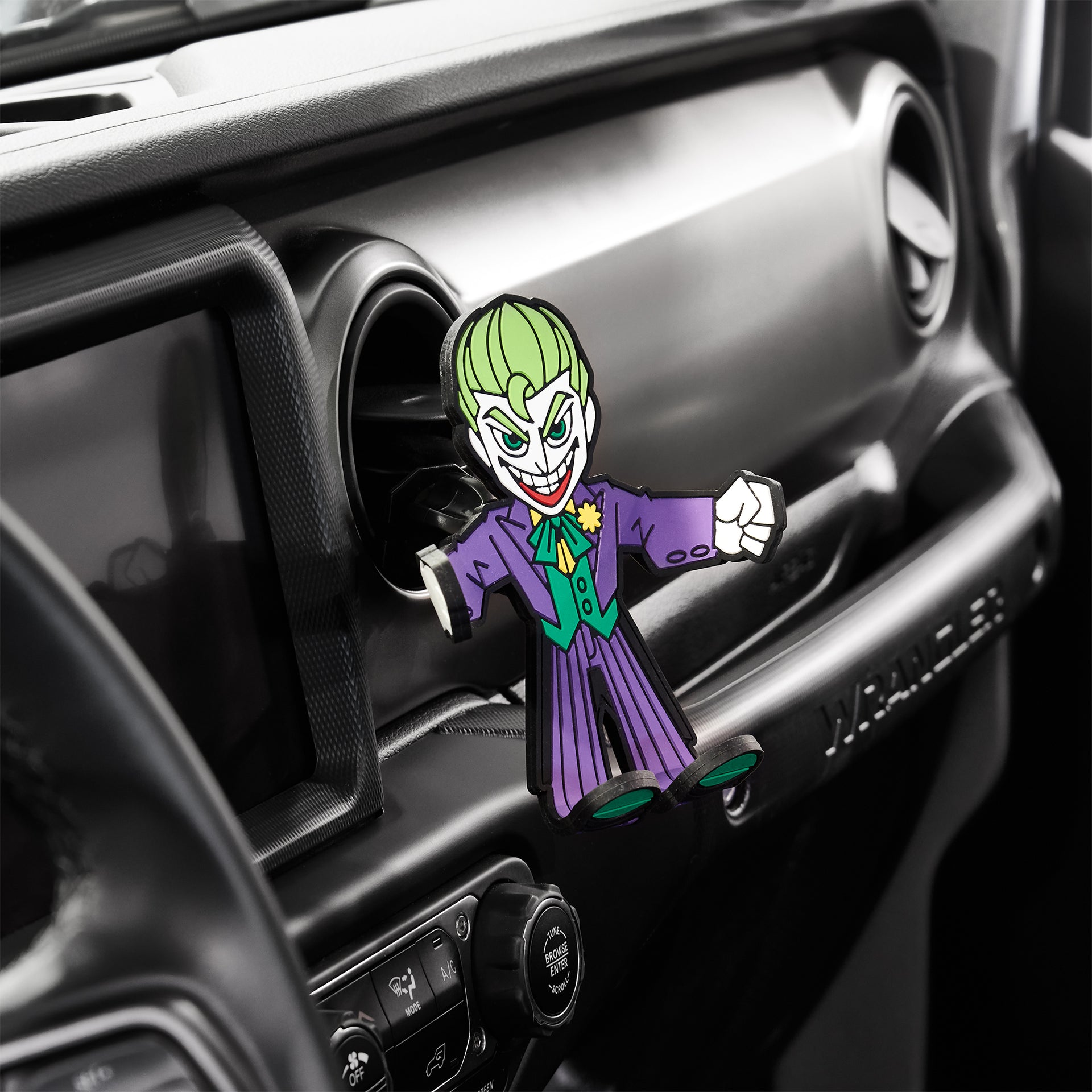 Image of DC Comics The Joker Hug Buddy attached to a car air vent ready to take your phone on another exciting journey