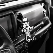 Image of Star Wars Stormtrooper Hug Buddy attached to a vehicle air vent waiting with arms and legs in a closed position waiting for a cell phone