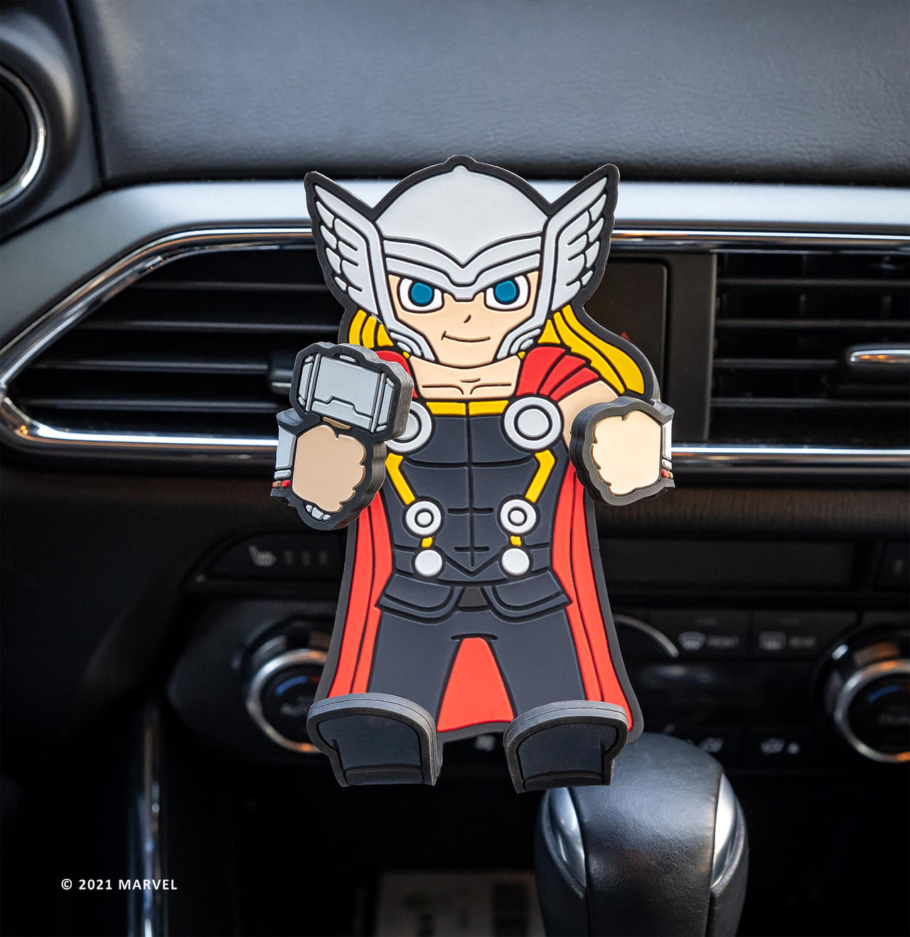 Image of Marvel Comics Thor Hug Buddy  attached to a car air vent with arms and legs folded in, ready to accept your phone or smart device and guide you on your next adventure