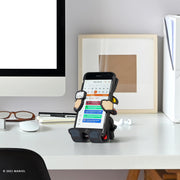 Image of Marvel Comics Thor Hug Buddy on top of a home office desk holding a cell phone with a calendar displayed on the screen
