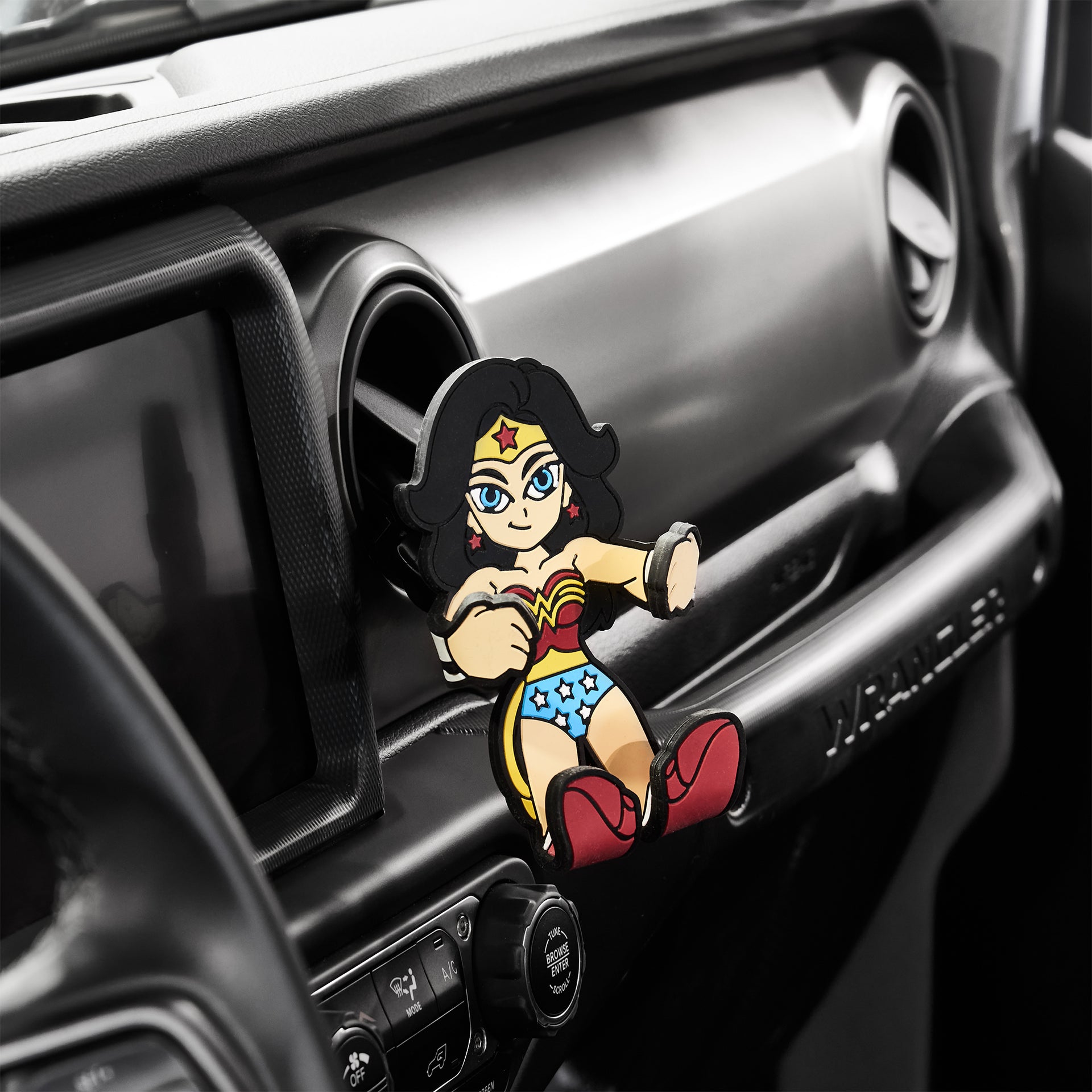 Image of DC Comics Wonder Woman Hug Buddy attached to a car air vent waiting for your cellphone or other smart device to grasp!