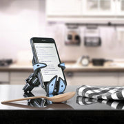 Image of Jaws the Shark Hug Buddy holding a cell phone on top of a kitchen island with a recipe displayed on the phone screen