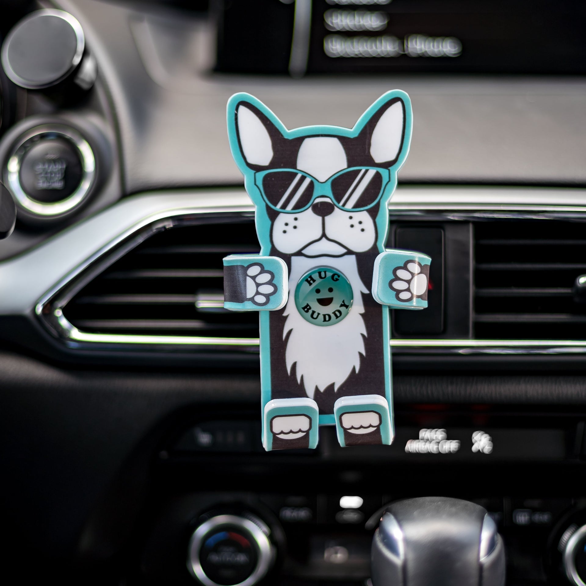 Image of Coolio the dog Hug Buddy attached to a car air vent ready to hold a cell phone or GPS or other smart device