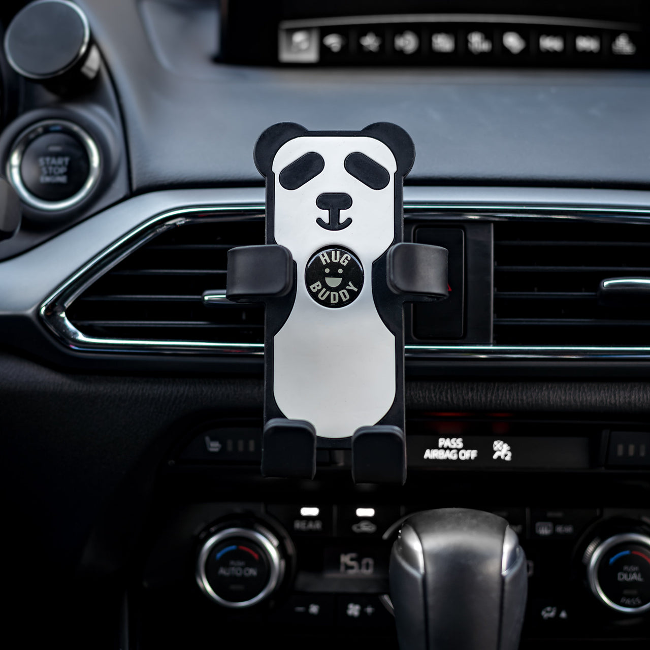 Image of Panda Hug Buddy attached to a car air vent, ready to hold your phone or device during your next commute!