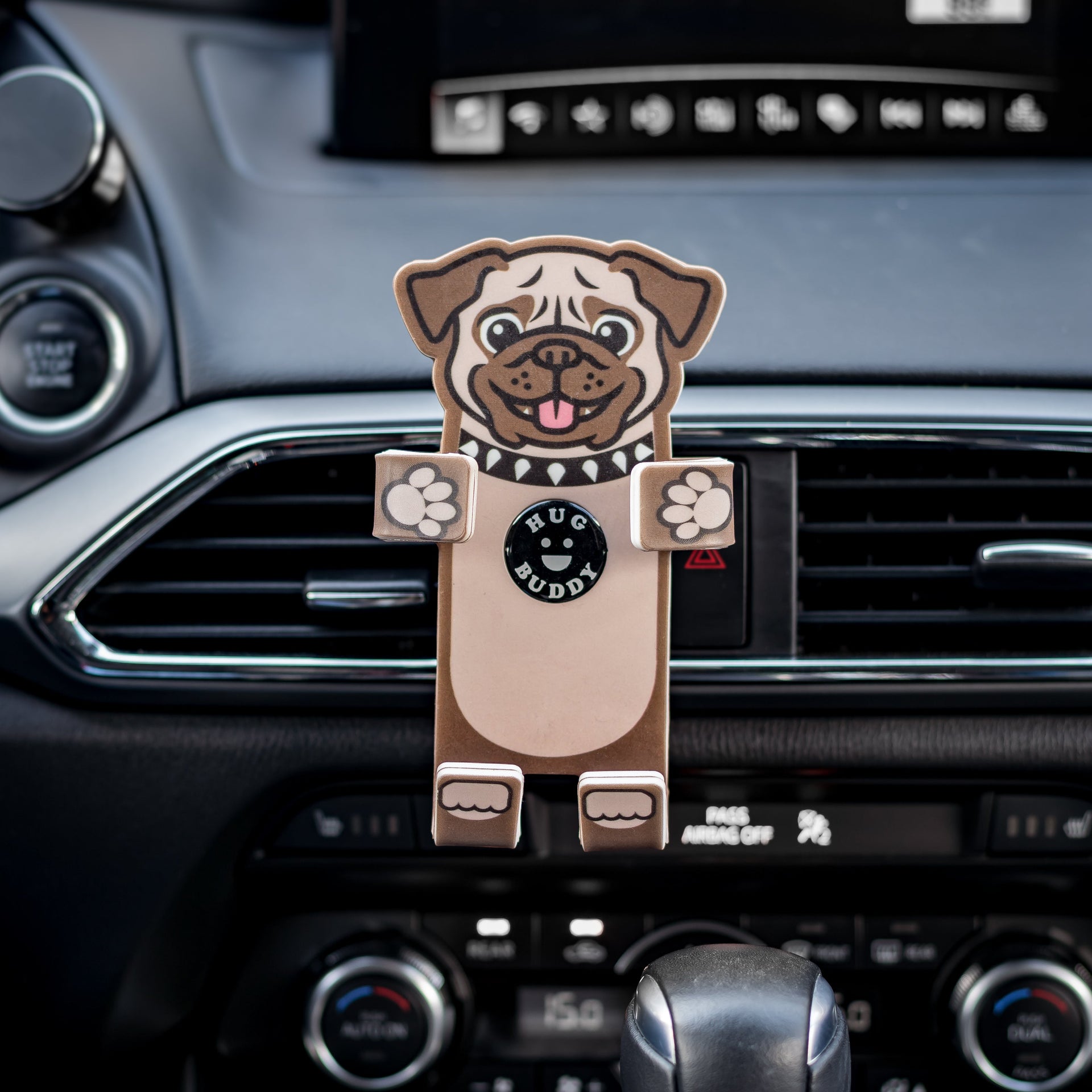 Image of Pug the dog Hug Buddy with arms and legs in the folded closed position ready to hold a cell-phone, while attached to a vehicle air vent
