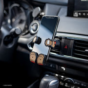 Image of Marvel Captain America Hug Buddy holding a phone, attached to a car air vent