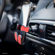 Image of Marvel Comics Spider-Man Hug Buddy attached to a car air vent holding a cell phone