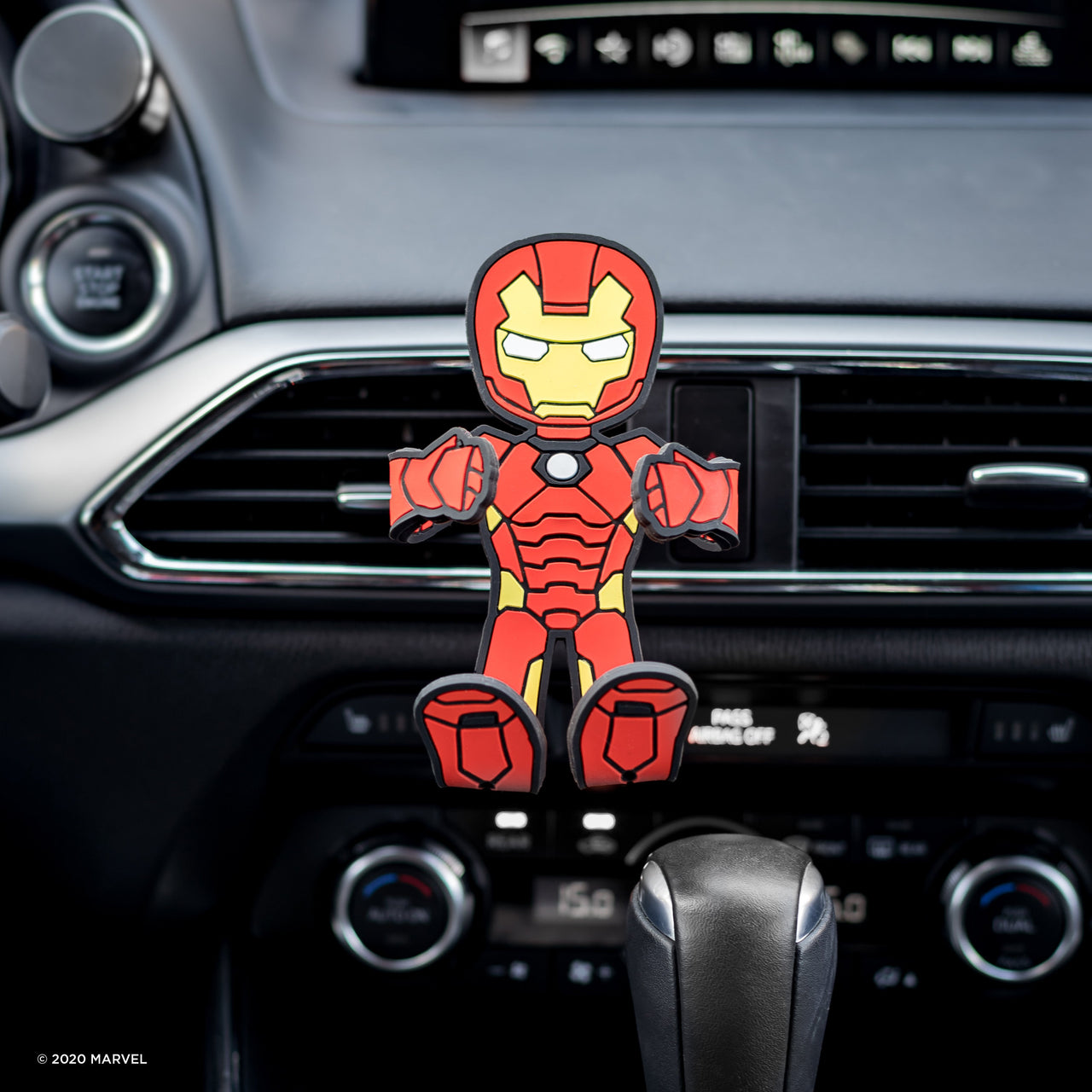 Image of Marvel Comics Iron Man Hug Buddy attached to a vehicle air vent with arms and legs in the folded closed position ready to grasp a cell-phone or smart device