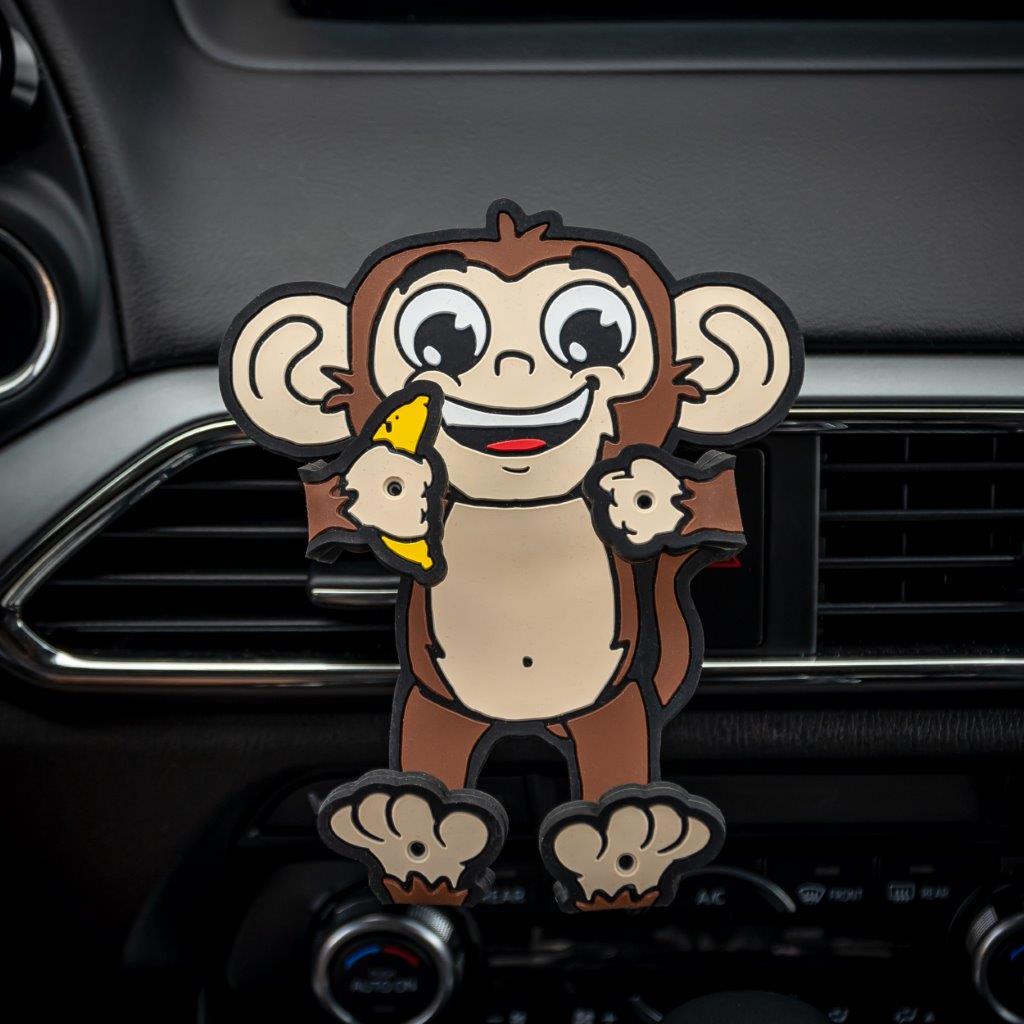 Image of Monkey Hug Buddy attached to a car air vent, ready to hold your cell-phone or any other smart device on your next journey