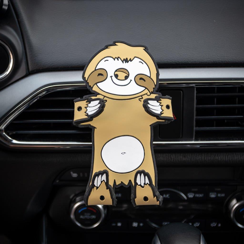 Image of Sloth Hug Buddy attached to a car air vent with arms and legs folded in, ready to grasp your smart phone or other device