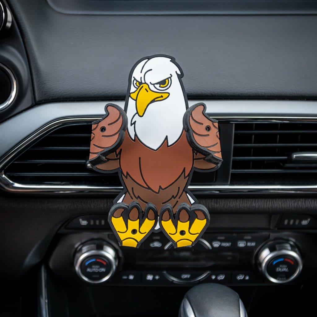 Image of Stripes the Eagle Hug Buddy attached to a car air vent with arms and legs in the closed position, ready to hold a phone or GPS or other smart device