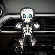 Image of Bones the Skeleton Hug Buddy attached to a vehicle air vent waiting to hold onto a phone or smart device!