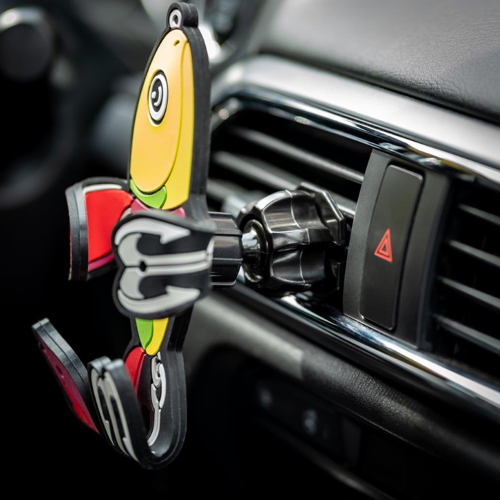 Image of Shaky the fish bait Hug Buddy attached to a car air vent with arms and legs folded, ready to hold your phone on your next adventure. Close-up image of the vent clip.
