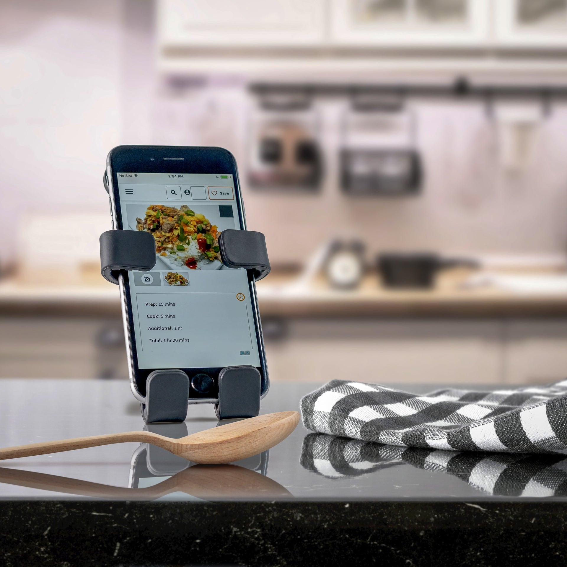 Image of Panda Hug Buddy sitting on a kitchen counter holding a phone with a recipe on the screen.